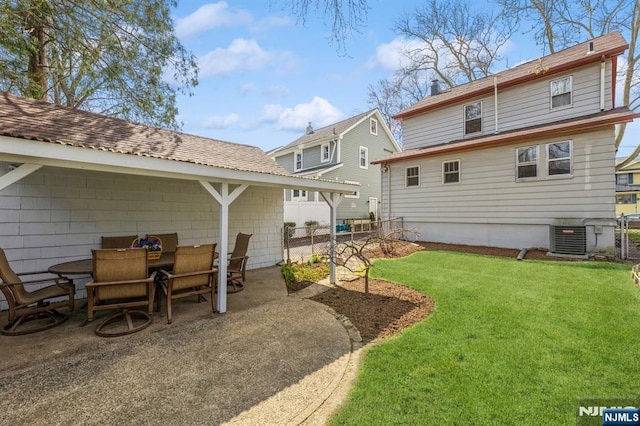 back of house with a yard, fence, central AC unit, a patio area, and outdoor dining space
