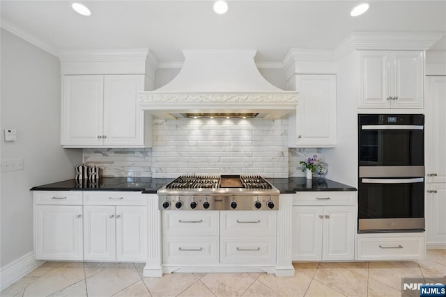 kitchen with dobule oven black, stainless steel gas cooktop, decorative backsplash, custom range hood, and white cabinets