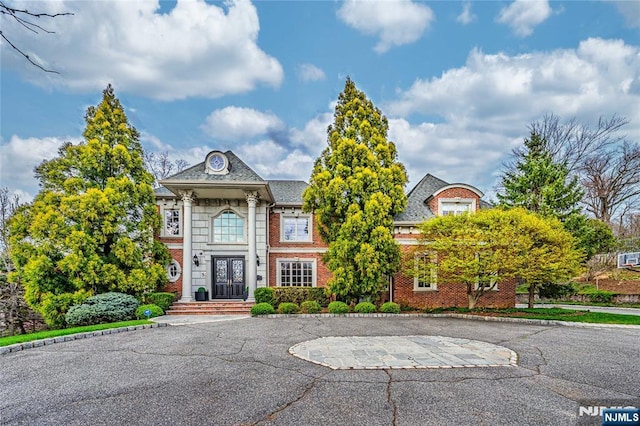 neoclassical home with brick siding