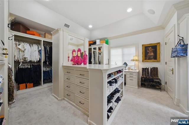 walk in closet with light colored carpet and visible vents