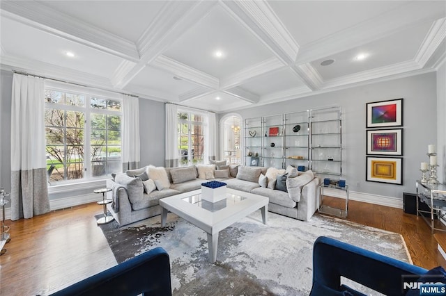 living room with wood finished floors, coffered ceiling, and crown molding