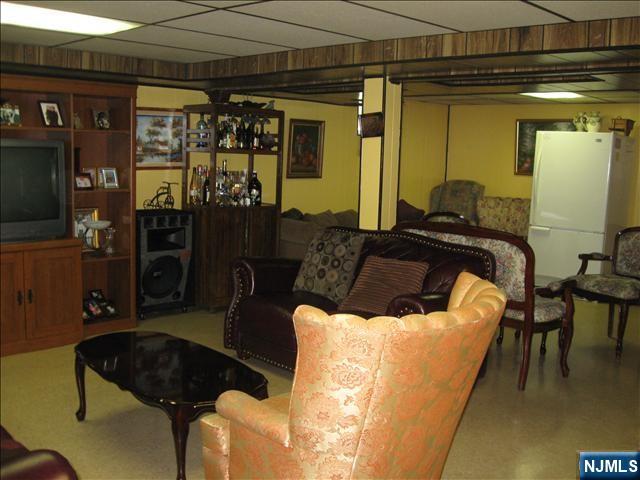 living area with a paneled ceiling