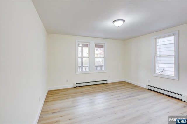 546 Morris St, Orange, NJ 07050 - empty room featuring wood finished floors, a baseboard heating unit, and baseboards