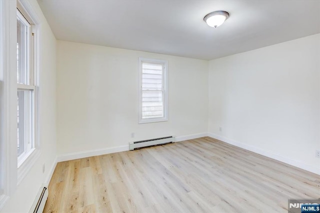 546 Morris St, Orange, NJ 07050 - spare room featuring baseboard heating, wood finished floors, a baseboard heating unit, and baseboards