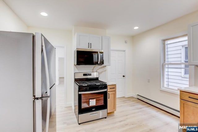 546 Morris St, Orange, NJ 07050 - kitchen with light wood-style floors, recessed lighting, baseboard heating, light countertops, and stainless steel appliances