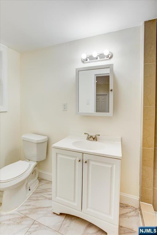 546 Morris St, Orange, NJ 07050 - bathroom featuring toilet, marble finish floor, vanity, and baseboards