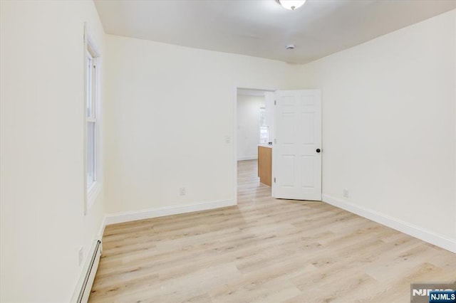 546 Morris St, Orange, NJ 07050 - unfurnished bedroom featuring light wood-type flooring, a baseboard heating unit, and baseboards