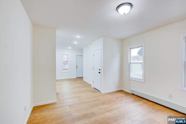 546 Morris St, Orange, NJ 07050 - unfurnished room featuring a baseboard radiator, recessed lighting, baseboards, and light wood-type flooring