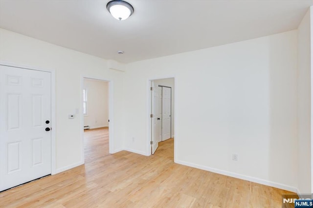 546 Morris St, Orange, NJ 07050 - spare room with baseboard heating, light wood-type flooring, and baseboards
