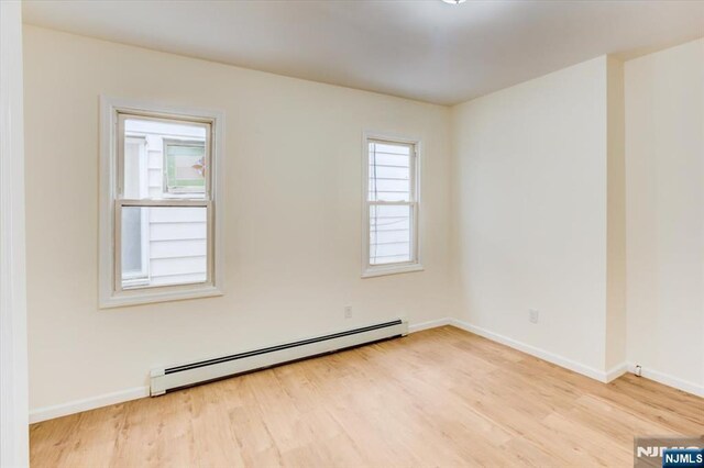 546 Morris St, Orange, NJ 07050 - unfurnished room featuring light wood finished floors, a baseboard radiator, and baseboards