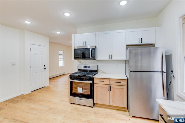 546 Morris St, Orange, NJ 07050 - kitchen featuring baseboards, light wood finished floors, recessed lighting, stainless steel appliances, and a baseboard heating unit