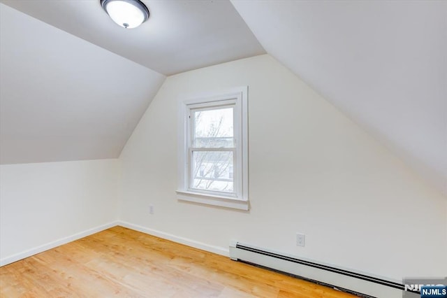546 Morris St, Orange, NJ 07050 - bonus room with baseboards, a baseboard heating unit, vaulted ceiling, and wood finished floors
