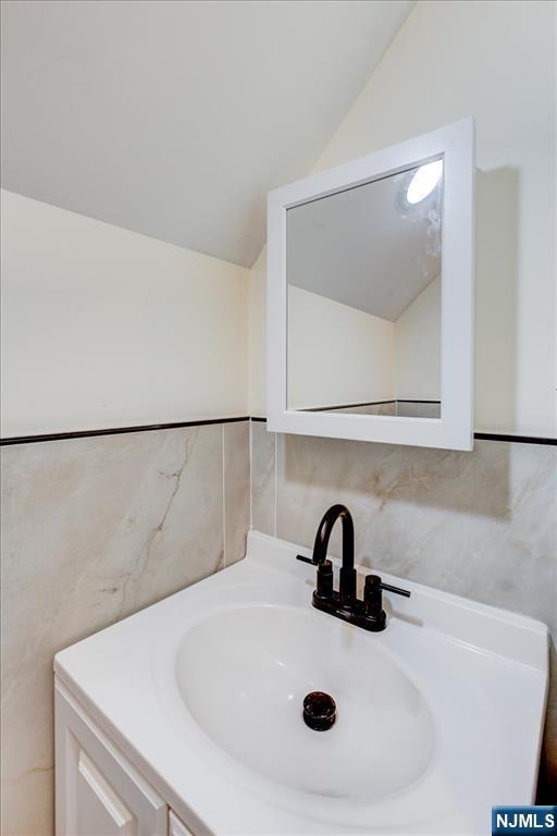 546 Morris St, Orange, NJ 07050 - bathroom with vanity and vaulted ceiling