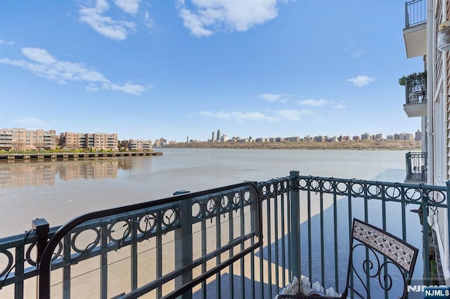 balcony with a water view and a city view
