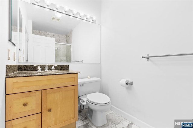 full bath featuring baseboards, toilet, vanity, marble finish floor, and a stall shower