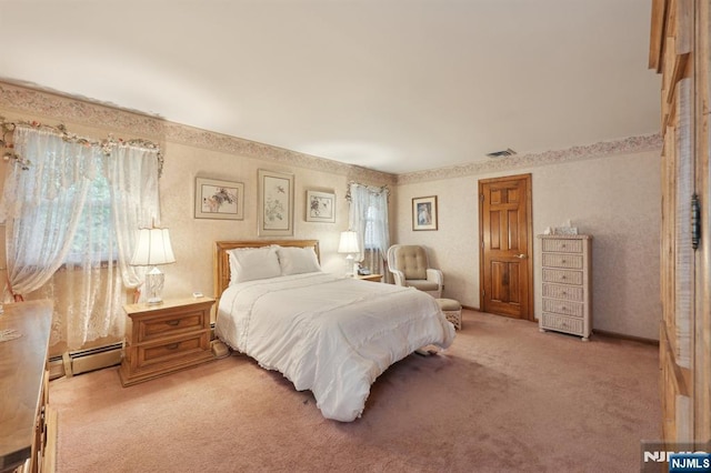 bedroom with a baseboard radiator and light carpet