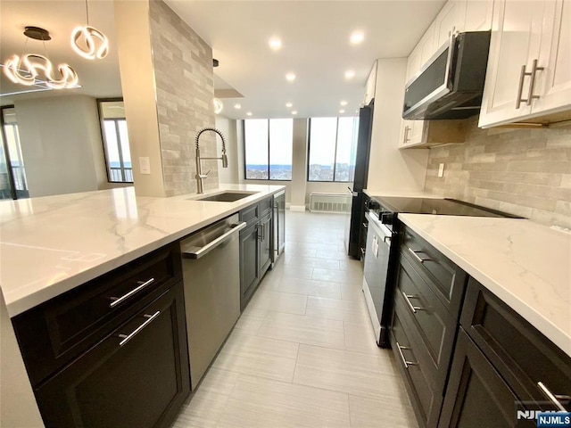 300 Winston Dr Unit 1722, Cliffside Park, NJ 07010 - kitchen with tasteful backsplash, a sink, a wealth of natural light, electric stove, and stainless steel dishwasher