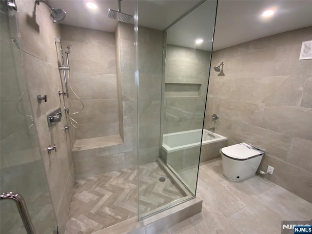 300 Winston Dr Unit 1722, Cliffside Park, NJ 07010 - bathroom featuring tile patterned flooring, tile walls, a tile shower, and toilet