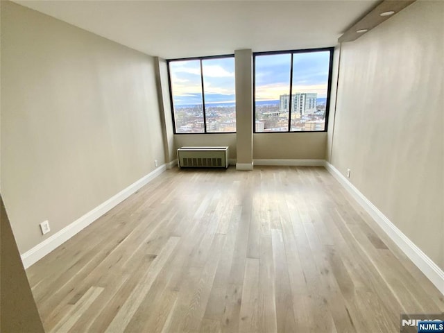 300 Winston Dr Unit 1722, Cliffside Park, NJ 07010 - spare room with baseboards, radiator, and wood finished floors