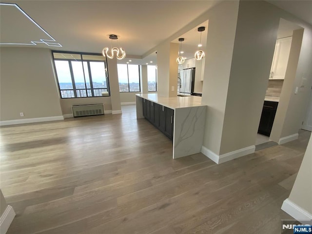 300 Winston Dr Unit 1722, Cliffside Park, NJ 07010 - unfurnished dining area featuring light wood-style floors, a notable chandelier, and baseboards