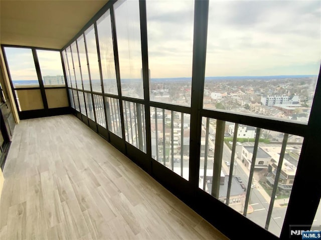 300 Winston Dr Unit 1722, Cliffside Park, NJ 07010 - unfurnished sunroom featuring wood finished floors, a view of city, and plenty of natural light