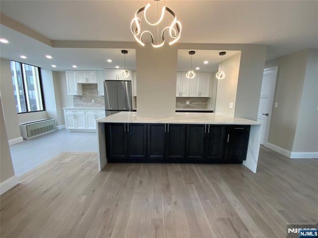 300 Winston Dr Unit 1722, Cliffside Park, NJ 07010 - kitchen featuring tasteful backsplash, white cabinets, freestanding refrigerator, and baseboards