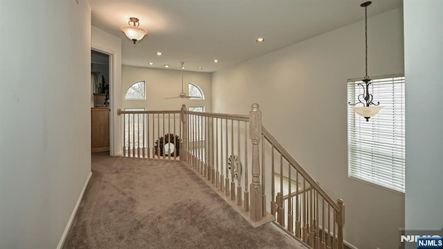 hall with carpet floors, baseboards, and recessed lighting