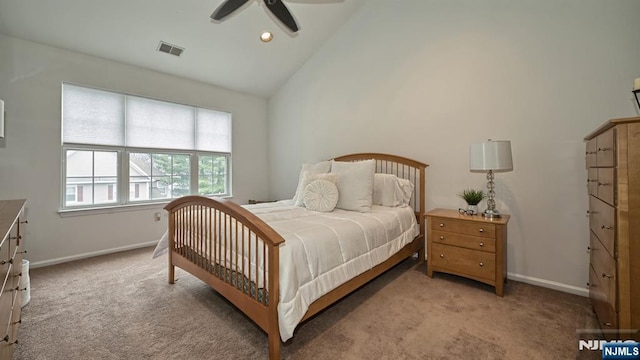 bedroom with high vaulted ceiling, light colored carpet, baseboards, and visible vents