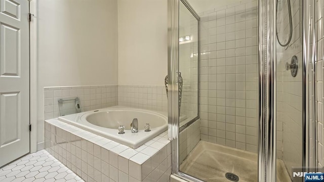 bathroom featuring a shower stall, tile patterned floors, and a garden tub