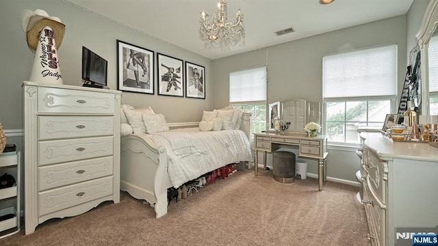 bedroom with a chandelier, visible vents, light carpet, and baseboards