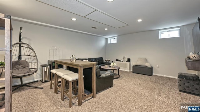 living area featuring a wealth of natural light, recessed lighting, and light colored carpet
