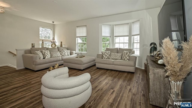 living room featuring dark wood-style flooring and baseboards