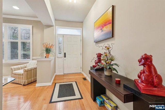 foyer with light wood-type flooring, baseboards, and recessed lighting