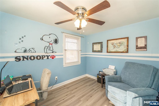 interior space featuring ceiling fan, baseboards, and wood finished floors