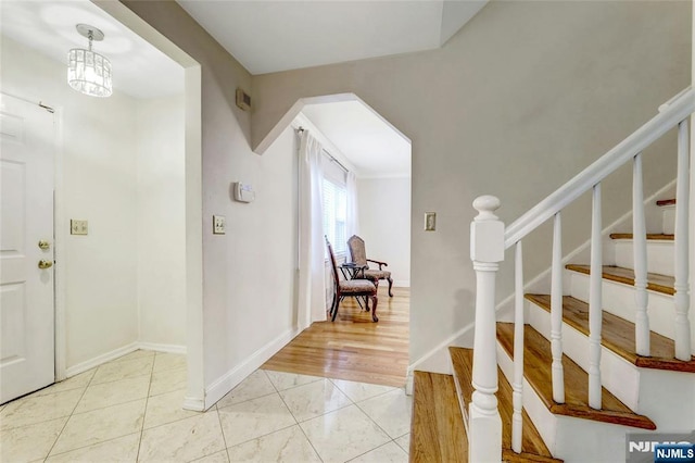 entryway featuring stairway and baseboards