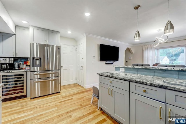 kitchen with stainless steel fridge, beverage cooler, gray cabinets, crown molding, and light wood-style flooring