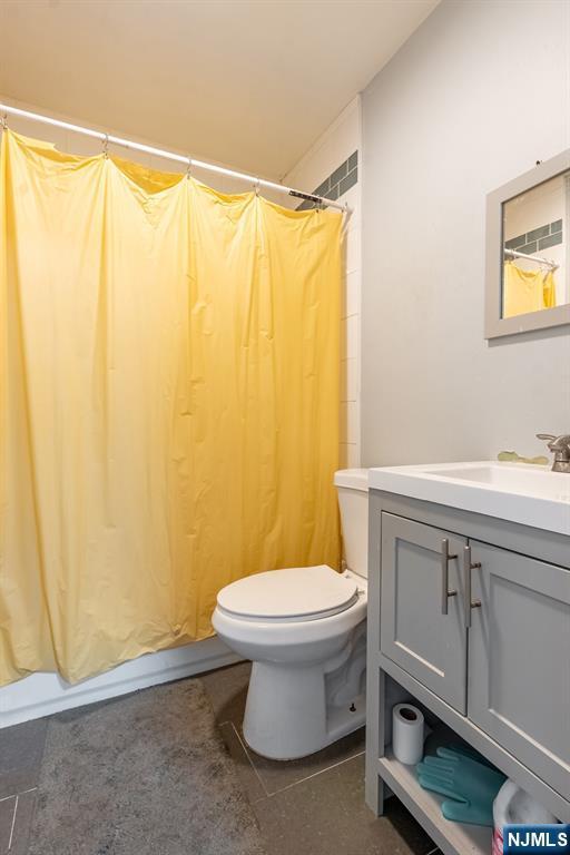 110 Montgomery St, Paterson, NJ 07501 - full bathroom with toilet, vanity, and a shower with curtain