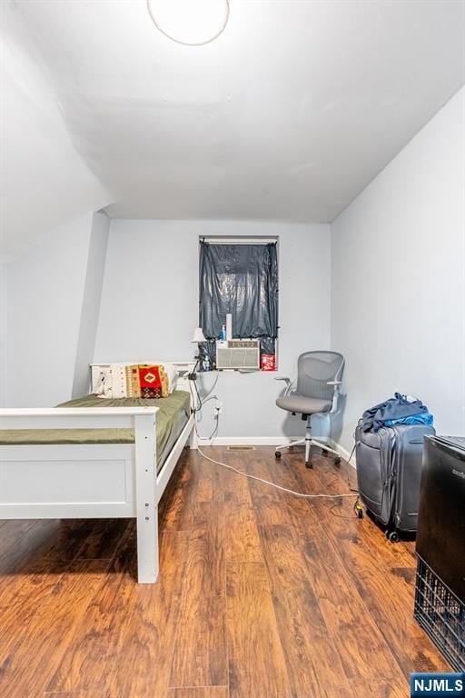 110 Montgomery St, Paterson, NJ 07501 - bedroom with cooling unit, baseboards, and wood finished floors