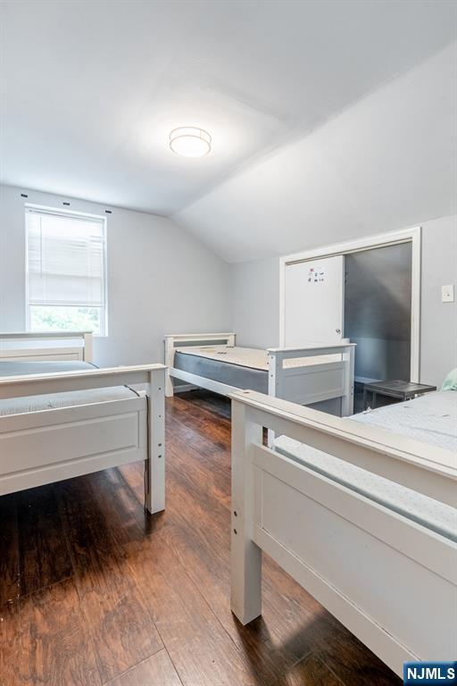 110 Montgomery St, Paterson, NJ 07501 - bedroom featuring wood finished floors and lofted ceiling