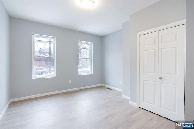 110 Montgomery St, Paterson, NJ 07501 - unfurnished bedroom featuring light wood-style flooring, a closet, and baseboards