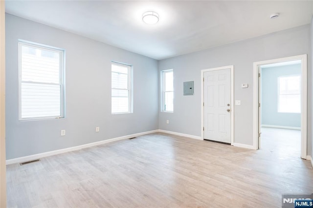 110 Montgomery St, Paterson, NJ 07501 - empty room with light wood-style floors, electric panel, visible vents, and baseboards