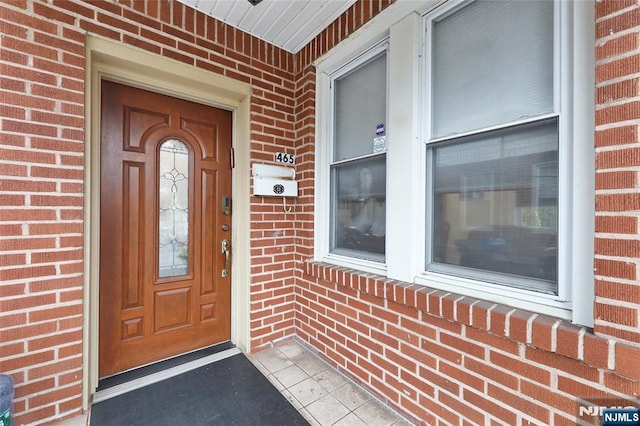 property entrance with brick siding