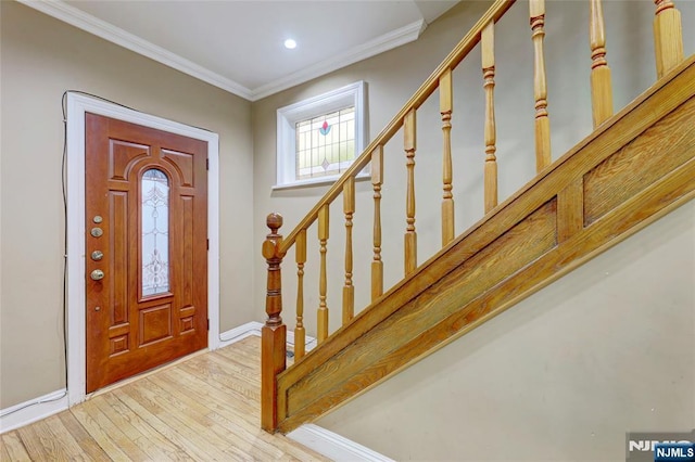 foyer entrance featuring baseboards, recessed lighting, stairway, crown molding, and wood-type flooring