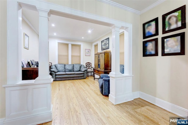 living room with recessed lighting, wood finished floors, crown molding, baseboards, and decorative columns