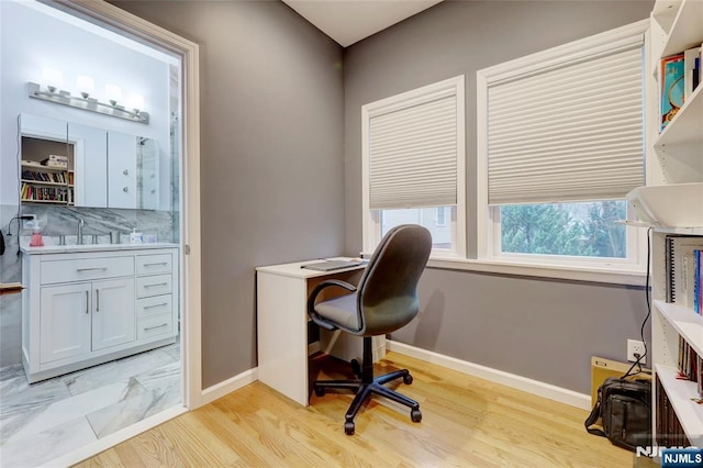 office area featuring baseboards and light wood-style floors