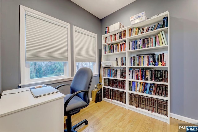 office space with wood finished floors and baseboards