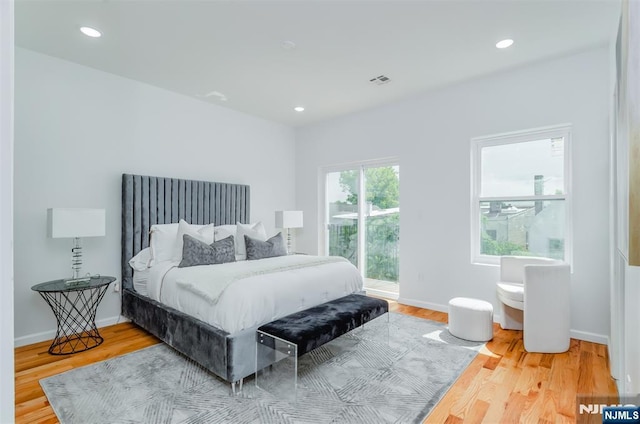 bedroom featuring recessed lighting, baseboards, access to outside, and wood finished floors