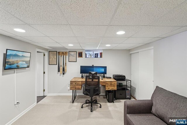 carpeted office space with baseboards, a drop ceiling, and recessed lighting