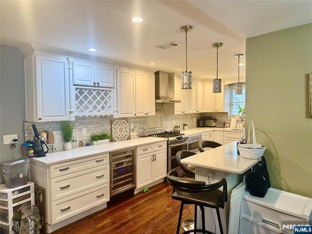 kitchen featuring double oven range, wall chimney exhaust hood, wine cooler, light countertops, and dark wood-style flooring