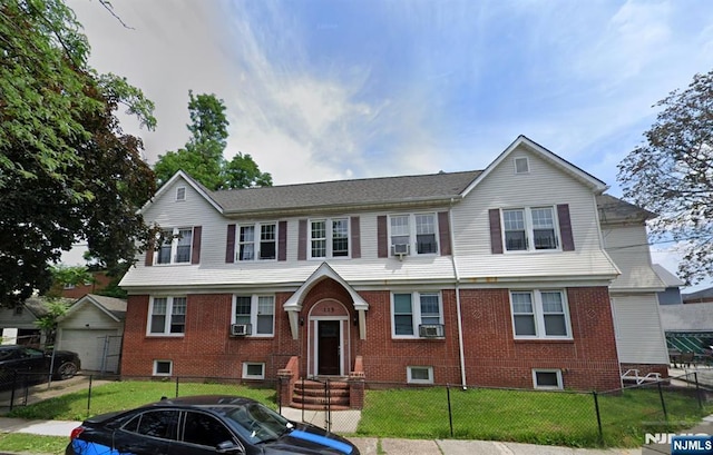 bi-level home with a front lawn, brick siding, cooling unit, and a fenced front yard